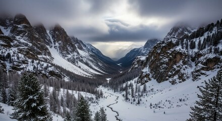 Serene panoramic view of snow-covered mountain valley under cloudy skies