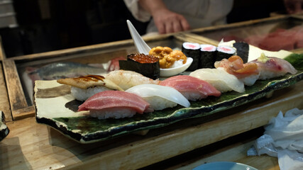 sushi in omakase on sushi bar in Japanese restaurant at Tokyo,  in Fish Market, Tsukiji Outer Market
