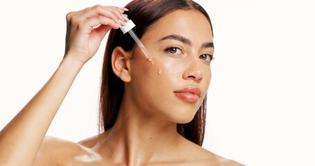 Beauty, woman and skincare with dropper in studio for skin hydration, healthy glow or hyaluronic...