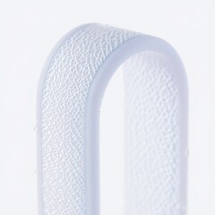 Close up of a textured white ribbon against a white background