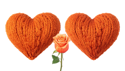 Two yarn hearts and rose, orange hues, dark background
