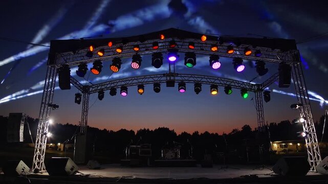 Festival Stage with Rotating Lights at Dusk