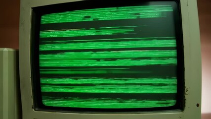 An old monitor showing green glitch lines on a dark background - Powered by Adobe