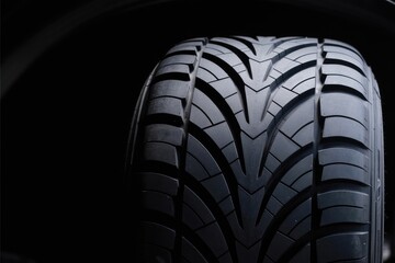 Close-Up of Car Tire Tread Pattern on Black Background