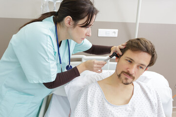 Fototapeta premium female doctor checks the ear