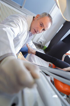 male physiotherapist massaging female foot