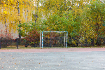 A soccer field with a goal and a fence