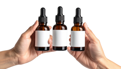 Hands holding three dark glass bottles with blank labels