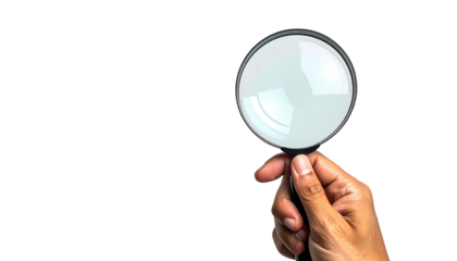 Hand holding magnifying glass, crisp focus, black backdrop