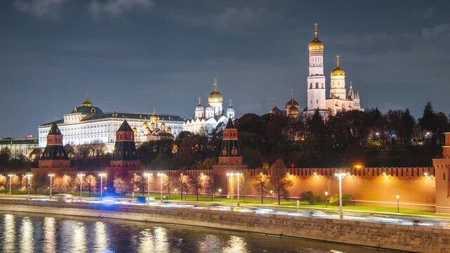 The Kremlin Embankment and the Moskva River, with fast-moving clouds in the night sky