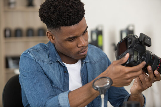 photographer inspecting his camera - Powered by Adobe