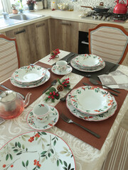 Table setting with bright tableware, berries, and twigs. Italian ceramic tableware. Aesthetics and lifestyle. Interior design. 