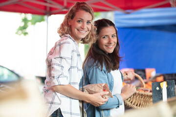 two women choosing a dairy products at supermarket