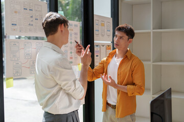 Ux ui designers collaborating on creative app wireframe planning