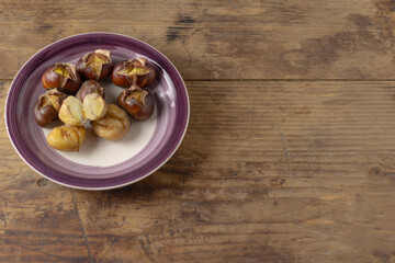 Roasted chestnut on a plate.Cleaned and in the shell.