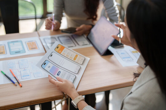Ui ux designers collaborating on mobile application prototype