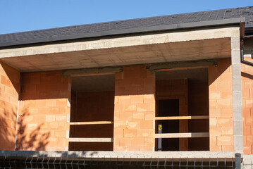 House construction site with brick walls.