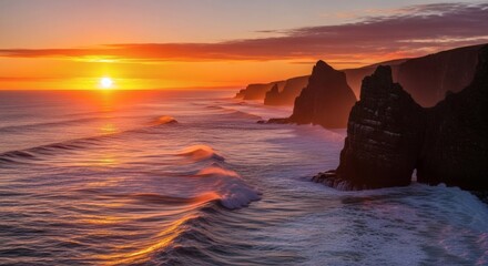 Coastal landscape captured at sunset with the sun casting its golden glow on sea cliffs and waves