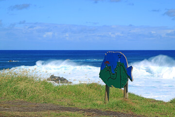 Big waves clashing on Pacific ocean coastline, Hanga Roa town, Easter island, Chile, South America