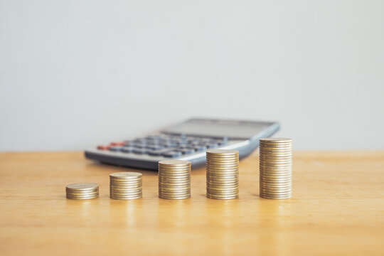 Financial concept with calculator and coins symbolizing savings and growth in business and investment