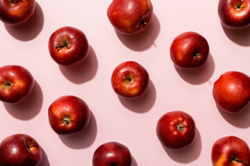 Many red apples on colored background, top view. Autumn pattern with fresh apple above view