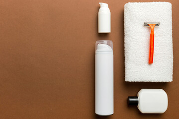 shaving man set. shaving machine, towel, lotion and shaving foam on colored background. Men bath Accessories top view