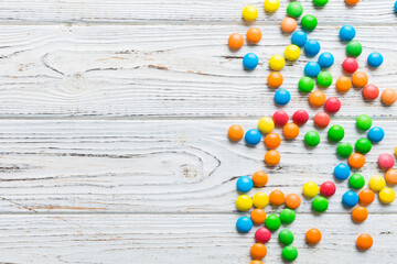 Mixed collection of colorful candy, on colored background. Flat lay, top view. frame of colorful chocolate coated candy