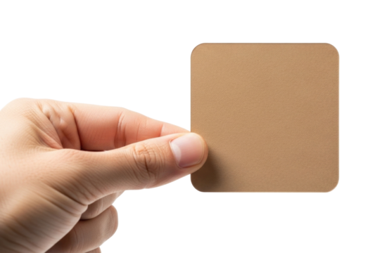 Human hand holding a small rounded rectangular brown card or tag isolated on transparent background