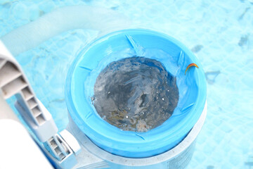 Top view of the blue skimmer for cleaning the pool in clear water. Contaminated pool cleaning concept