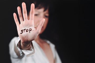 Woman's hand with written stop