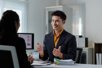 Business man giving thumbs up during meeting