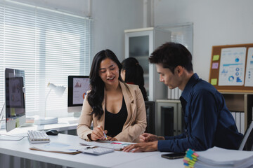 Business professionals collaborating on financial data in office