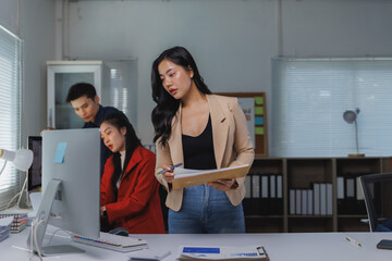 Business team collaborating on project in modern office