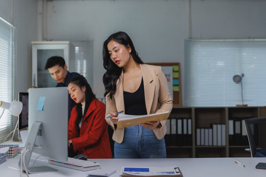 Business team collaborating on project in modern office