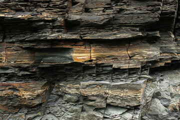 Black yellow rock texture. Mountain surface. Close-up. Gray stone background with copy space for design. Wide banner. Panoramic.