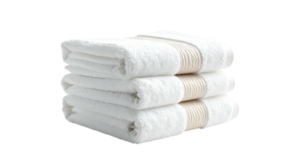 Stacked, folded, fluffy white towels against a dark background