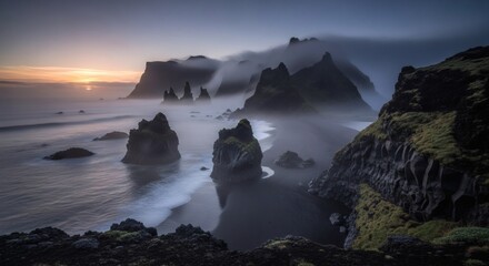 Rocky formations on a black sand beach, shrouded in fog under a dusky sky, ocean's edge