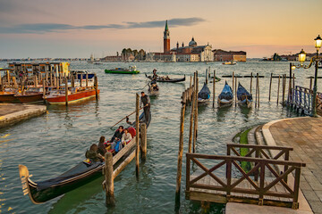 The photograph depicts St Mark's Square (Piazza San Marco) in Venice. Dominating the square is the bell tower (Campanile di San Marco)