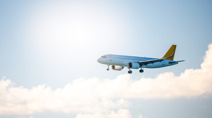 Commercial airplane with yellow tail flying above clouds during landing, representing travel, aviation industry, logistics and air transportation.