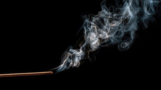 Thin trail of smoke rising from a burning incense stick on a black background. - Powered by Adobe