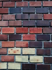 Fototapeta premium Textured detail of the brick wall of the Sacred Heart of Jesus Jesuit Church (Jézus Szíve Jezsuita Templom) in Budapest, featuring colorful bricks that highlight the rich craftsmanship