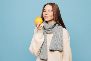 Young woman she wear pink sweater scarf hold in hand orange citrus fruit close eyes isolated on...