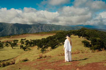 Tranquil person in white embracing peaceful mountain solitude