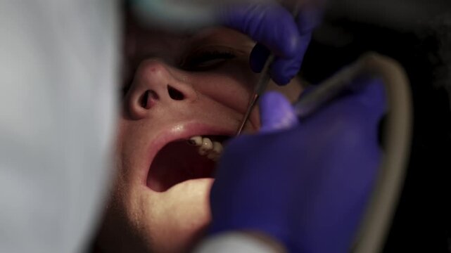 Dentist surgeon is using a variety of instruments to remove a patient old bridge in preparation process for new implant prosthetics teeth