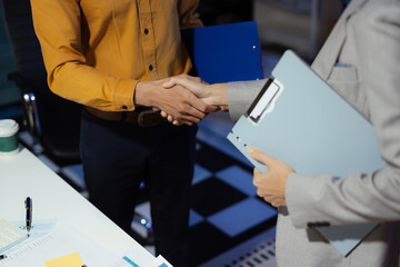 Business men and women shake hands confidently professional investor working with new startup project at an office meeting.