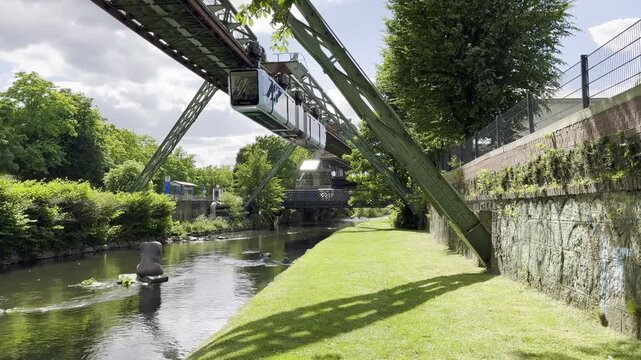 Famous suspension monorail passing overhead River Wupper where an elephant 'Tuffi' fell from the carriage in 1950 - Wuppertal, Germany