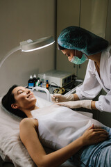 Dermatologist performs precise radio wave mole removal using radiofrequency surgery. Close-up of radio wave dermatologic mole excision. Radiofrequency mole removal under clinical conditions.