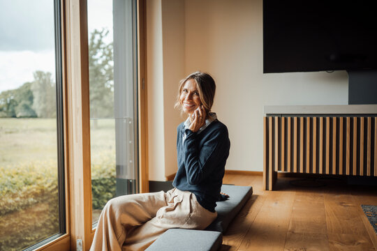 Female entrepreneur enjoying work-life balance in modern office with outlook