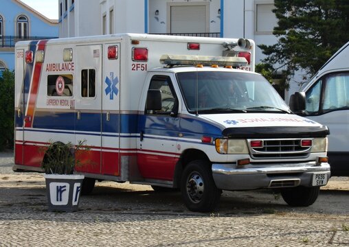 American ambulance vehicle parked on cobblestone street