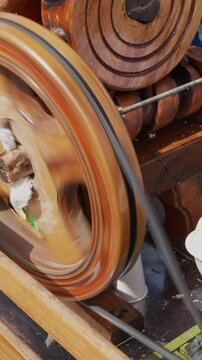 Close-up shot of a trapiche milling sugarcane smoothly in bright light. The vertical video captures intricate machinery details, perfect for mobile, social media, and more.